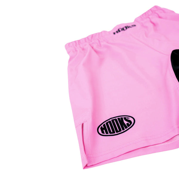 Hooks Rose Fusion Shorts, close-up of front thigh showing oval logo, side split hem, and elasticated waistband in pink