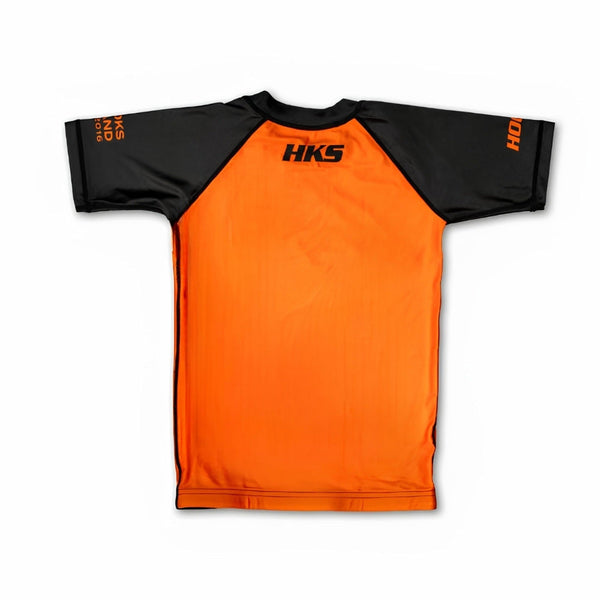 Hooks Kids 2026 Ranked BJJ Rash Guard in Orange, back view showing orange body with black raglan sleeves and HKS logo at yoke