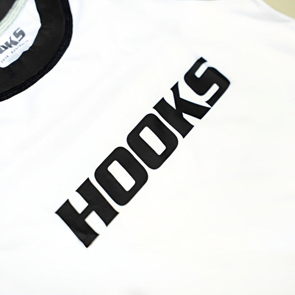 Hooks Kids 2026 Ranked BJJ Rash Guard White, close-up of bold black HOOKS chest logo print