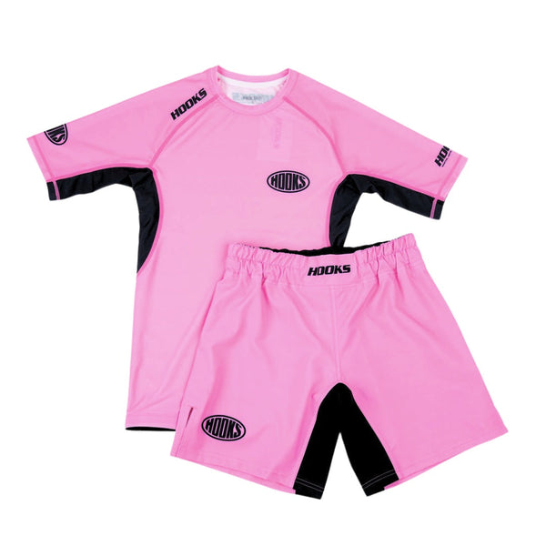 Hooks Rose Fusion Shorts, front flat lay in pink and black, shown alongside matching short-sleeve rash guard as a set