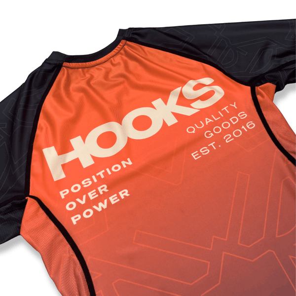 Hooks Short Sleeve Rash Guard Fire Horse, close-up of front chest showing orange-to-red gradient and Position Over Power