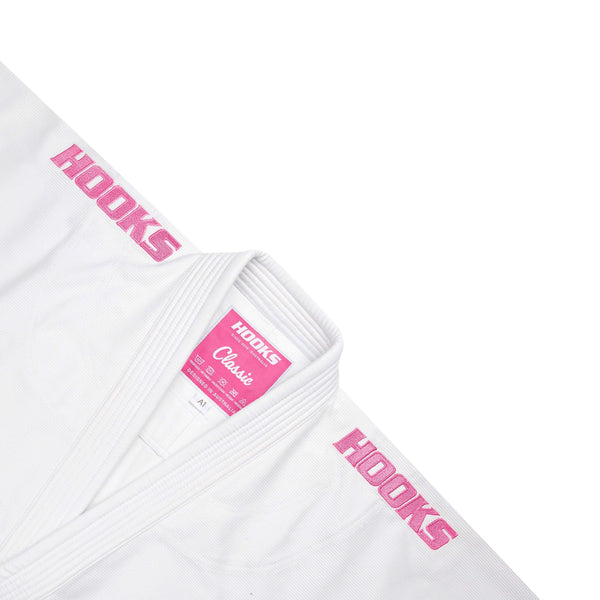 Hooks Kids Classic BJJ Gi White & Pink, close-up of lapel and collar showing pink Classic label and pink embroidered sleeve