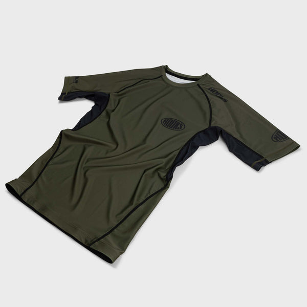 Hooks short sleeve BJJ rashguard, front flat lay in olive green with black side panels and tonal chest logo.