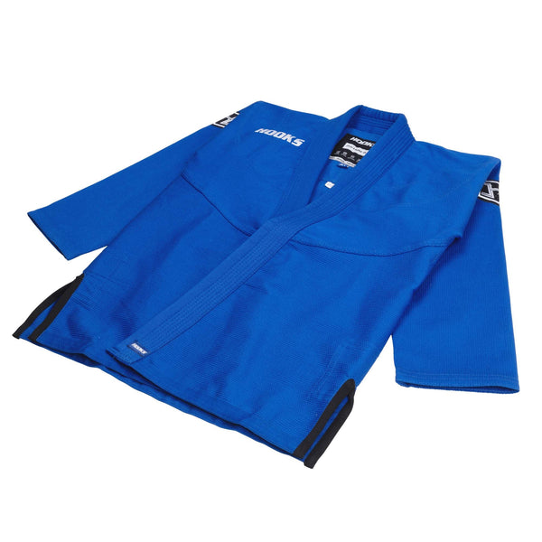 Hooks blue kids BJJ gi jacket, angled flat lay showing lapel, black trim on sleeves and hem, and woven chest label