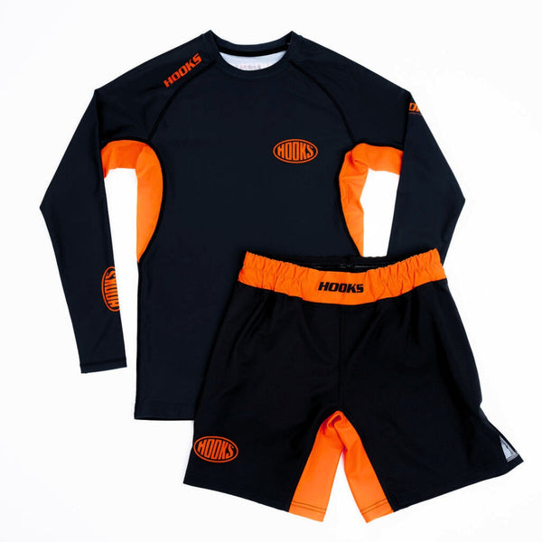 Hooks Long Sleeve Rash Guard Black Inferno, front flat lay paired with matching black and orange shorts