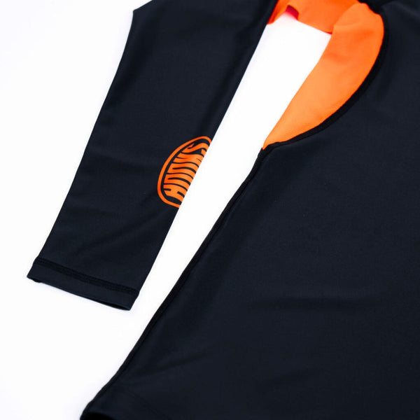 Hooks Long Sleeve Rash Guard Black Inferno, close-up of sleeve logo and orange collar detail