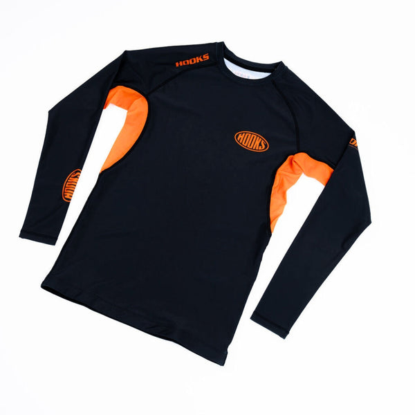 Hooks Long Sleeve Rash Guard Black Inferno, front flat lay showing black body with orange side panels and oval chest logo