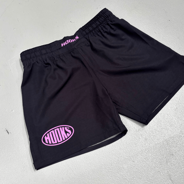 Hooks Sports Shorts Rose Noir, front flat lay showing pink oval logo on left leg and pink branded waistband