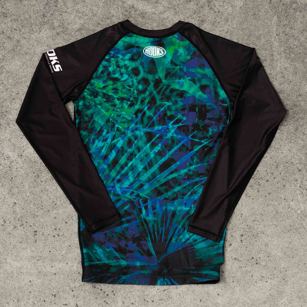Hooks Long Sleeve Rash Guard Jungle Reign, back flat lay showing teal and blue tropical print with black raglan sleeves