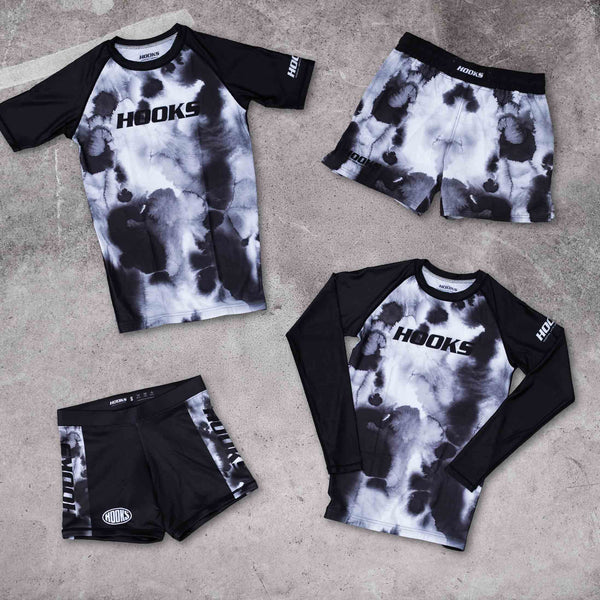 Hooks BJJ Short Sleeve Rash Guard Black Mist, flat lay front view alongside matching long sleeve, fight shorts