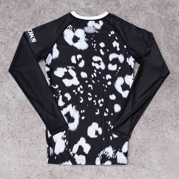 Hooks Long Sleeve Rash Guard – Prowl, back view flat lay showing black and white leopard print body with solid black raglan