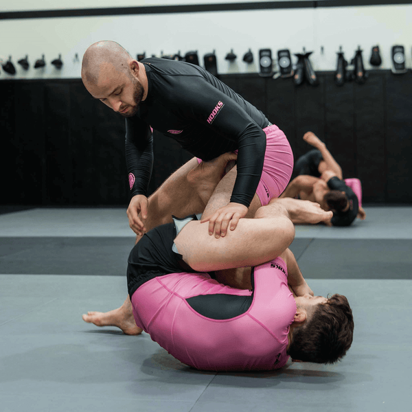 Hooks Rose Fusion Short Sleeve Rash Guard, worn during live BJJ sparring on the mat with a training partner