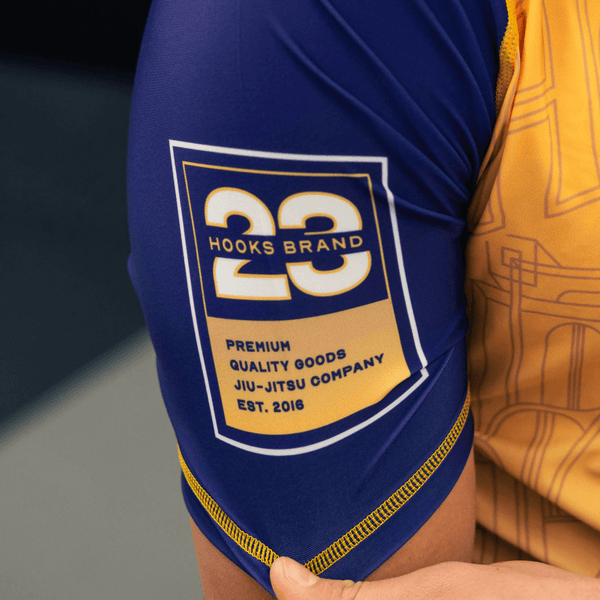 Close-up of the right sleeve print on the yellow Showtime rashguard.