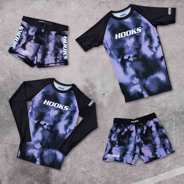 Hooks BJJ Short Sleeve Rash Guard Violet Haze, front flat lay shown alongside matching long sleeve rash guard and two shorts
