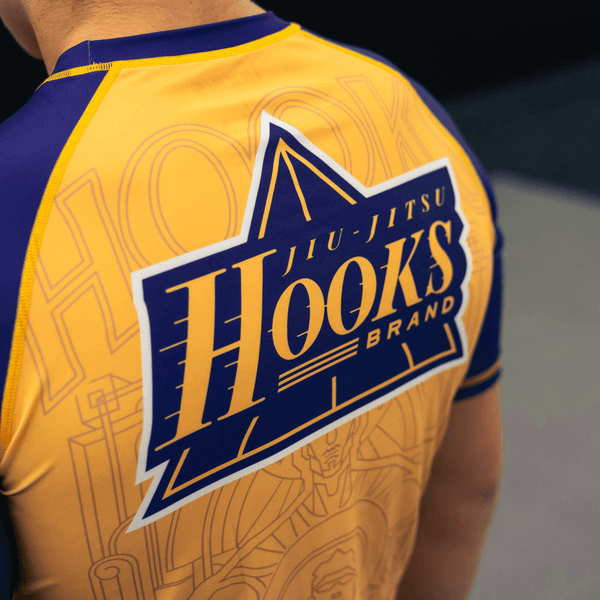 Front and back design details of the yellow Showtime rashguard.