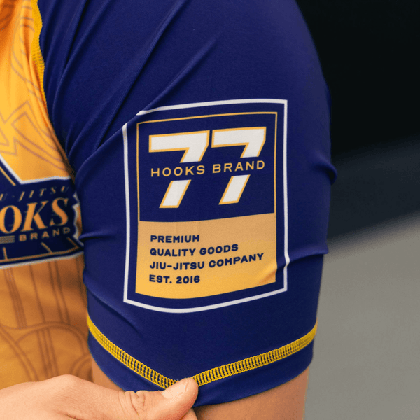 Close-up of the left sleeve print on the yellow Showtime rashguard.