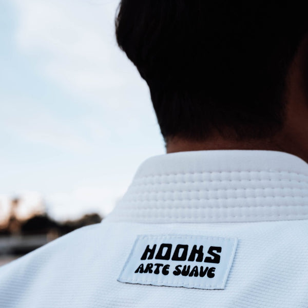 White Hooks Arte Suave BJJ Gi with label detail, showcasing the quality fabric and craftsmanship