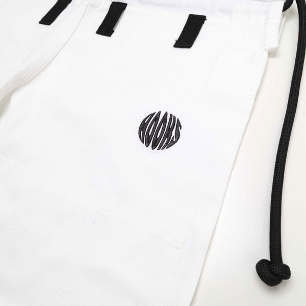 Close-up of white fabric with black ‘HOOKS’ stylized lettering and drawstrings, part of martial arts attire