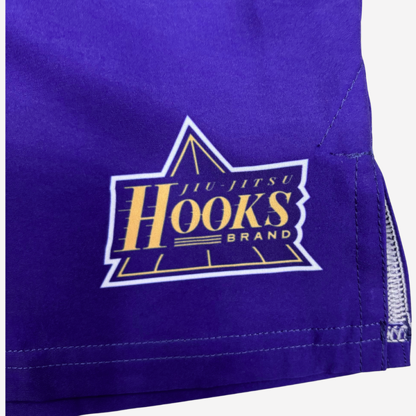 Purple shorts with 'Hooks Brand' logo on a white background