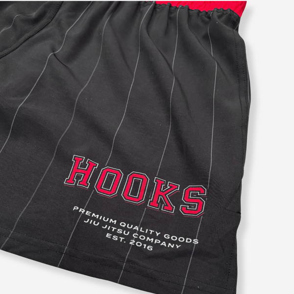 Black shorts with red text 'HOOKS' and white text on a white background