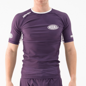 Hooks Fusion Short Sleeve Rash Guard in Plum, front view worn, purple with white side panels and chest logo