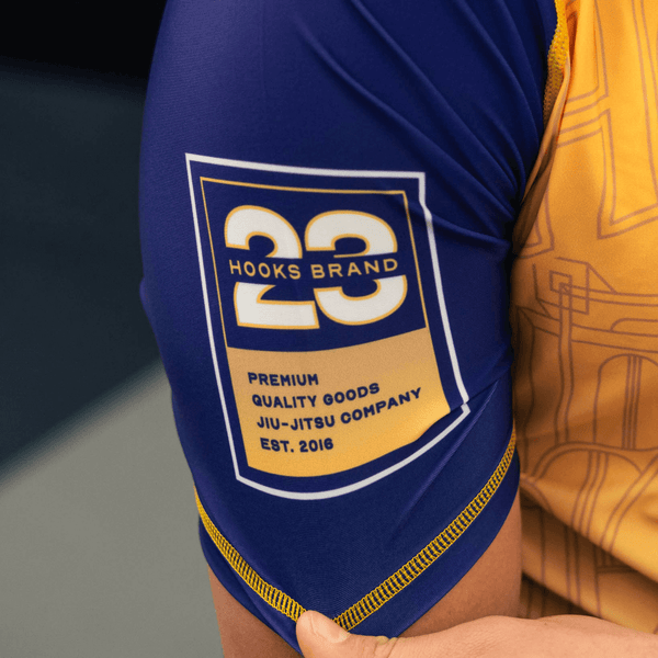 Close-up of the right sleeve print on the yellow Showtime rashguard.