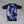 Hooks short sleeve rash guard, back view flat lay, violet haze watercolour print body with black raglan sleeves