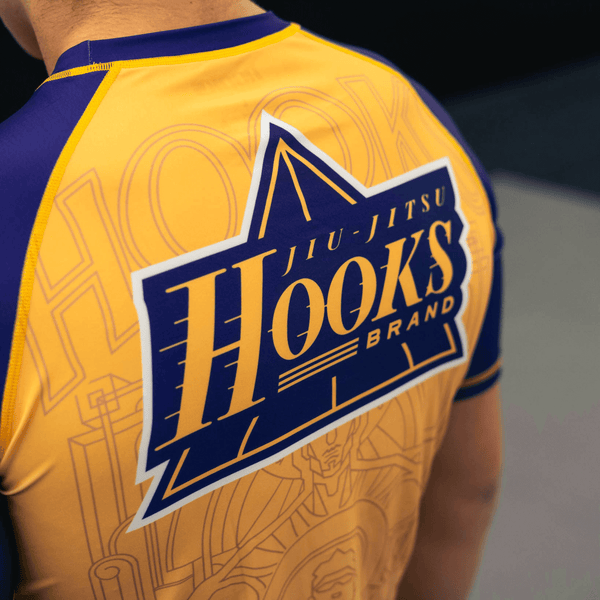 Front and back design details of the yellow Showtime rashguard.